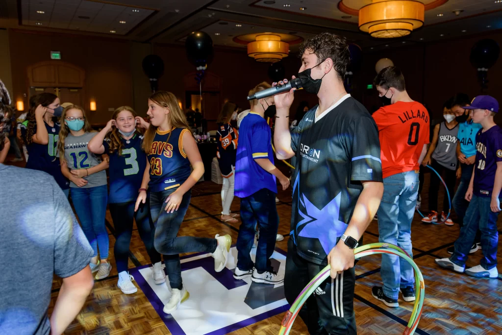 The MC organizing a hula hoop game at the party.