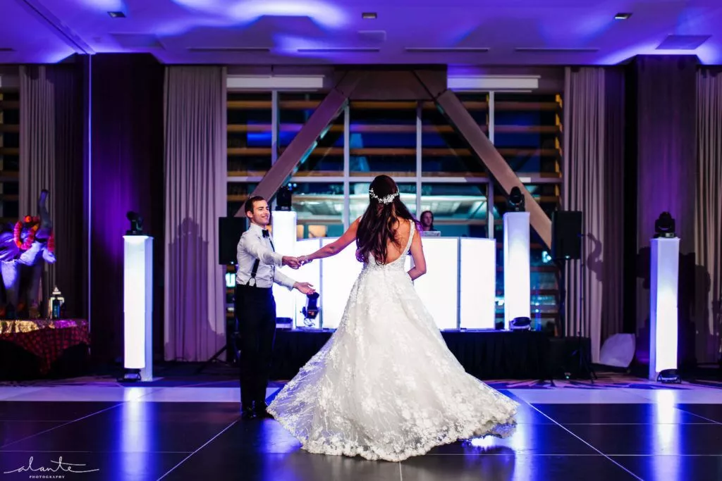 A newlywed couple, starting a casual and joyful dance.