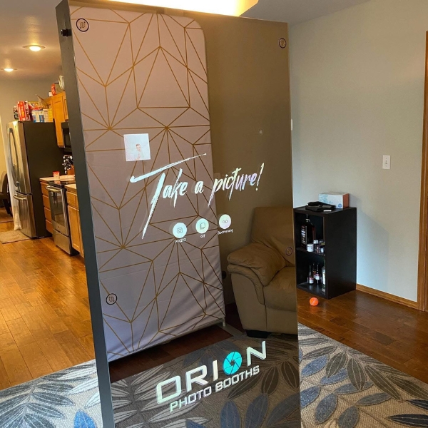 Image of a professional camera at the photo booth with event details.