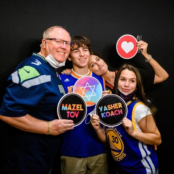 Image of people having an engaging experience in a photo booth at their special event.